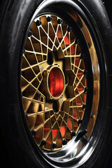 old retro stylish wheels collapsible two-component with a gold center and shiny rims for car tuning long exposure photo to simulate movement