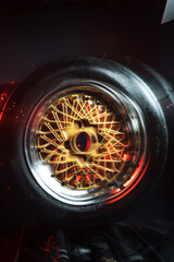 old retro stylish wheels collapsible two-component with a gold center and shiny rims for car tuning long exposure photo to simulate movement