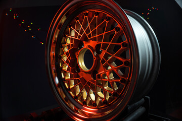 old retro stylish wheels collapsible two-component with a gold center and shiny rims for car tuning long exposure photo to simulate movement