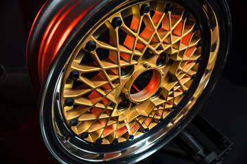 old retro stylish wheels collapsible two-component with a gold center and shiny rims for car tuning long exposure photo to simulate movement