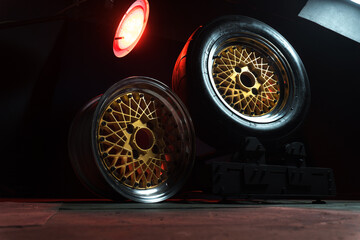 old retro stylish wheels collapsible two-component with a gold center and shiny rims for car tuning long exposure photo to simulate movement