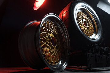 old retro stylish wheels collapsible two-component with a gold center and shiny rims for car tuning long exposure photo to simulate movement