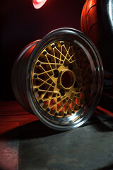 old retro stylish wheels collapsible two-component with a gold center and shiny rims for car tuning long exposure photo to simulate movement