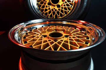 old retro stylish wheels collapsible two-component with a gold center and shiny rims for car tuning long exposure photo to simulate movement