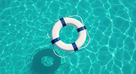 White life buoy floating on the surface of vibrant turquoise swimming pool water in bright sunshine.