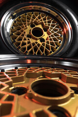 old retro stylish wheels collapsible two-component with a gold center and shiny rims for car tuning long exposure photo to simulate movement