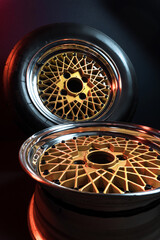 old retro stylish wheels collapsible two-component with a gold center and shiny rims for car tuning long exposure photo to simulate movement