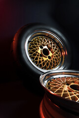 old retro stylish wheels collapsible two-component with a gold center and shiny rims for car tuning long exposure photo to simulate movement
