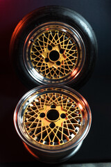 old retro stylish wheels collapsible two-component with a gold center and shiny rims for car tuning long exposure photo to simulate movement