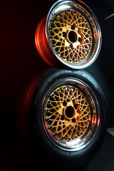 old retro stylish wheels collapsible two-component with a gold center and shiny rims for car tuning long exposure photo to simulate movement