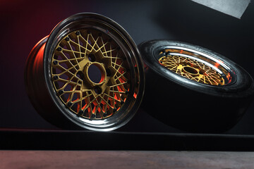 old retro stylish wheels collapsible two-component with a gold center and shiny rims for car tuning long exposure photo to simulate movement
