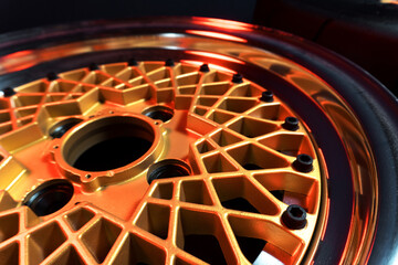 old retro stylish wheels collapsible two-component with a gold center and shiny rims for car tuning long exposure photo to simulate movement