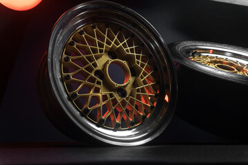 old retro stylish wheels collapsible two-component with a gold center and shiny rims for car tuning long exposure photo to simulate movement