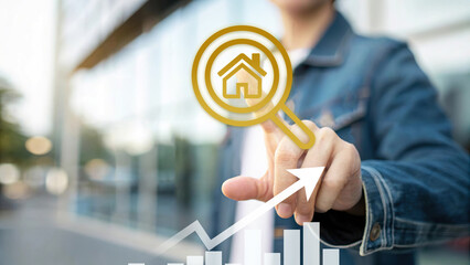 Hand pointing at digital house search icon with rising bar chart and arrow, real estate market growth, property investment, housing analytics, and smart technology in modern urban background.
