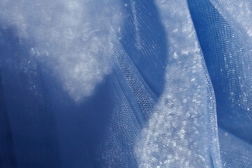 Soft blue tulle fabric with bokeh light effect, abstract dreamy background