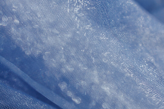Soft blue tulle fabric with bokeh light effect, abstract dreamy background