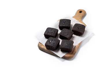 Homemade chocolate brownies on cutting board isolated on white background. Copy space