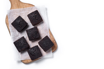 Homemade chocolate brownies on cutting board isolated on white background. Top view. Copy space