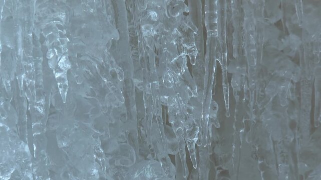 Detailed close up view of layered, textured and jagged icicles inside the Eben Ice Caves in Michigan, USA.