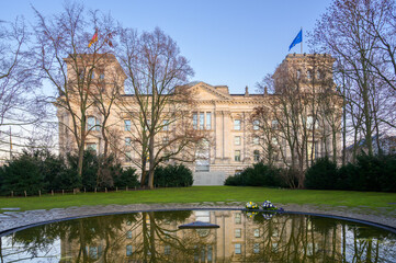 Berlin, Germany - December 20, 2019: Memorial honoring Sinti and Roma stands beside Reichstag Building in early morning light