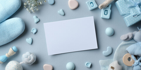 Blank milestone card is surrounded by pastel blue baby items, including booties, toys, and decorative hearts, creating soft and charming atmosphere