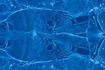 Blue water with ripples on the surface. Defocus blurred transparent blue colored clear calm water...