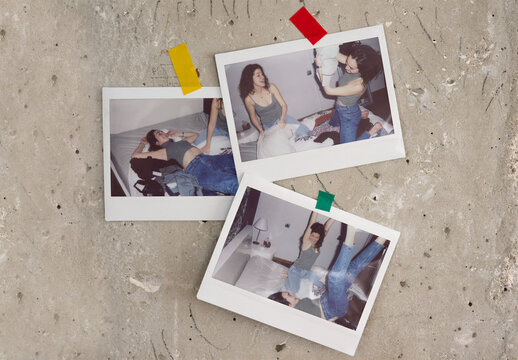 Three wide instant photos are taped to a textured surface