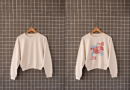 A simple sweater drapes on a tiled wall