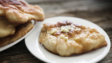 Hungarian food langos with garlic and olive oil on plate
