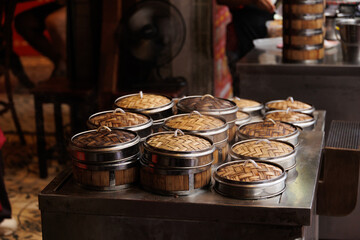 Chinese hot steam cooking food Yumcha or Dim sum in Bamboo Steamer Basket at Chinese restaurant