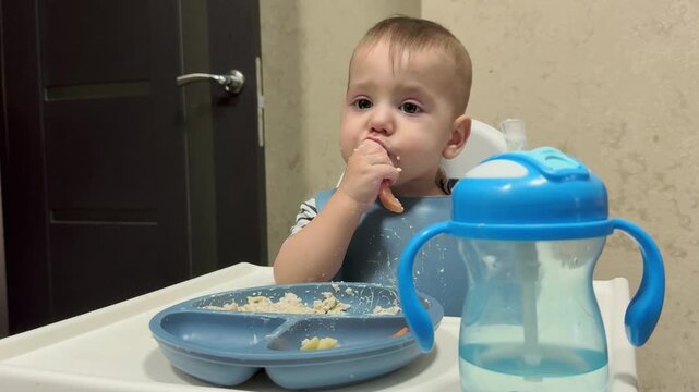Toddler enjoying meal in high chair