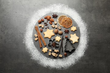Christmas celebration. Circle made with flour, cookies and spices on grey table, flat lay