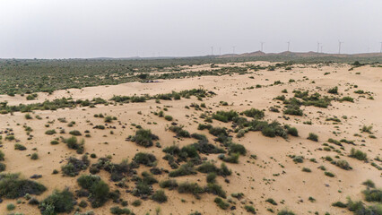 Aerial view of Khuri sand dunes in Jaisalmer, Rajasthan, after sunset, showing desert vegetation like Khejri, Rohida, Babool, and Ker trees with soft twilight sky and golden sand textures.