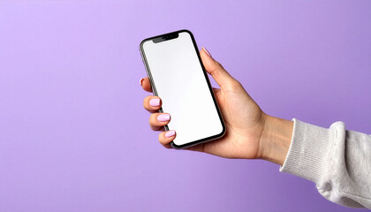 Female hand holding smartphone with blank screen on purple background