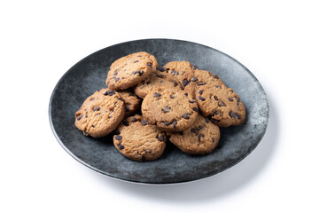 Baked chocolate chip cookies on black plate isolated on white background