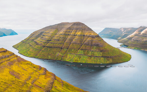 Aerial view of the striking verdant slopes of Kalsoy island contrast with the deep blue waters, a serene landscape, Klaksv&Atilde;&shy;k, Northern Isles, Faroe Islands.