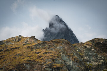 Mt. Matterhorn with clouds in the Swiss Alps during a base camp hike in Zermatt.