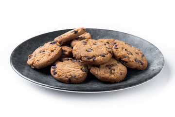 Baked chocolate chip cookies on black plate isolated on white background
