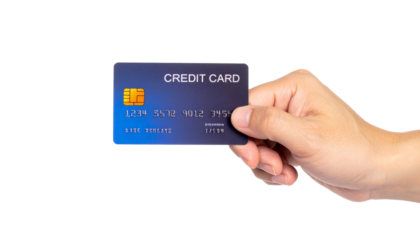 A hand holding a credit card