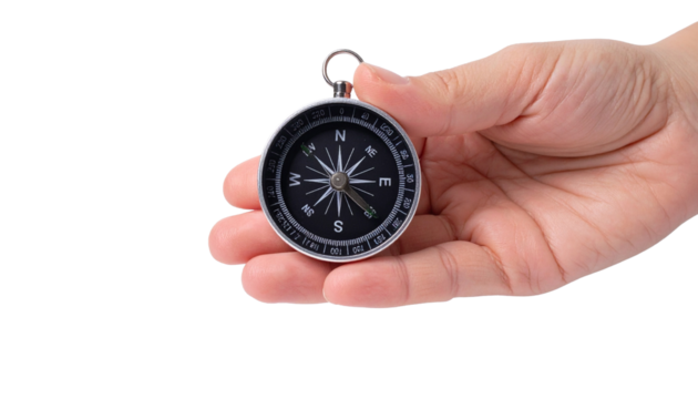 A hand holds a compass, guiding direction