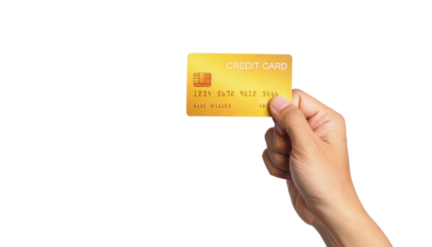 A hand holding a golden credit card, a symbol of finance and transactions.