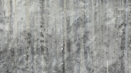 The old gray cement wall is stained, peeled, and has a peeling surface. The wall has been stained with black stains over time. Walls of ancient buildings. Texture and background image.