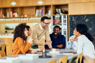 Collaborative Team Meeting With Lively Discussion Around Table In Modern Office Café Setting