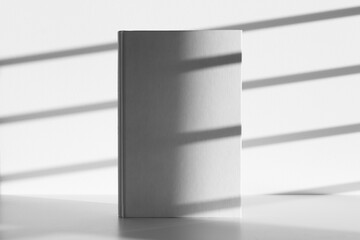 White hardcover notebook mockup, shadow overlay, sunlight