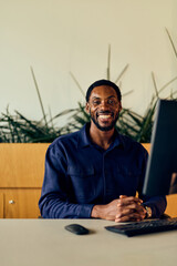 African-american Man at Desk Smiling With Computer in Office Setting