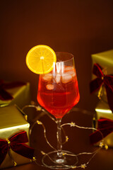 festive holiday cocktail with gifts and fairy lights