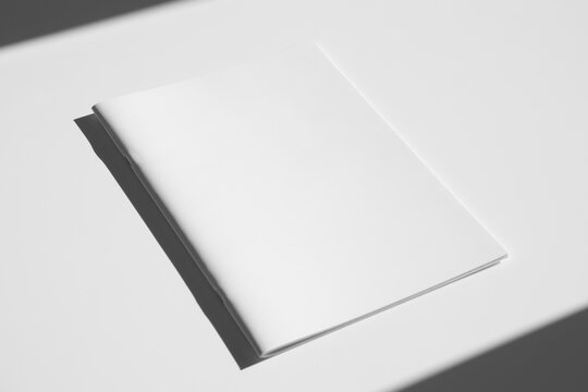 A4 portrait magazine, catalog cover mockup, saddle stitch, hard shadows