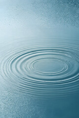 Circles on Water: Capturing the essence of tranquility, concentric rings ripple outwards across a serene water surface, reflecting the sky above.