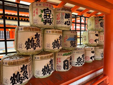 Traditional Japanese sake barrels with calligraphy at Shinto shrine Japan