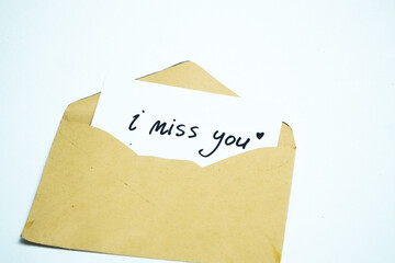 I miss you note. Delivering message concept. craft letter envelope on white background. Brown envelope as background